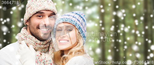 Image of happy couple in winter wear over forest and snow