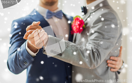 Image of close up of happy male gay couple dancing