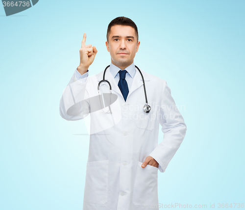 Image of male doctor in white coat pointing finger up