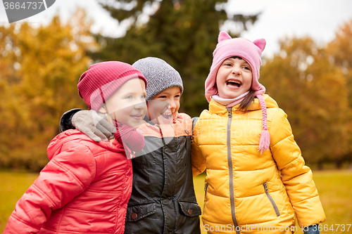 Image of group of happy children hugging in autumn park