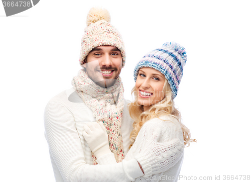 Image of smiling couple in winter clothes hugging