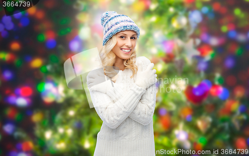 Image of smiling young woman in winter hat and sweater