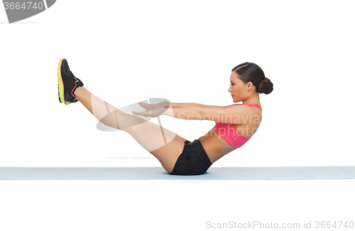 Image of sporty woman doing exercise on the floor