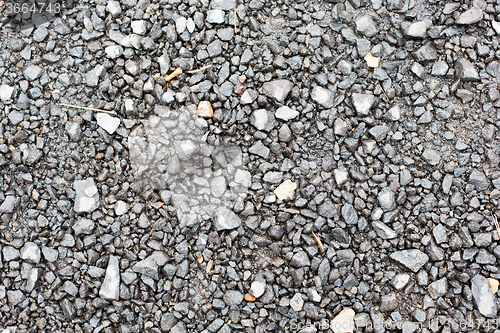 Image of close up of gray macadam stones on ground