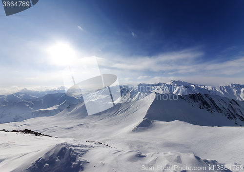 Image of View on off-piste slope and sky with sun
