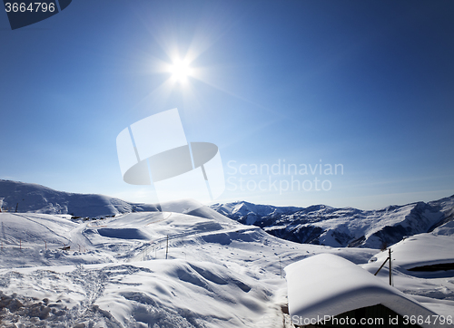 Image of Ski resort and sky with sun