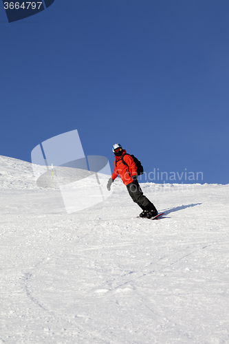 Image of Snowboarder on ski slope at nice day