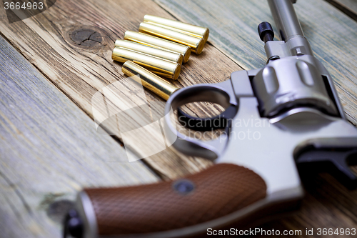 Image of vintage revolver with cartridges