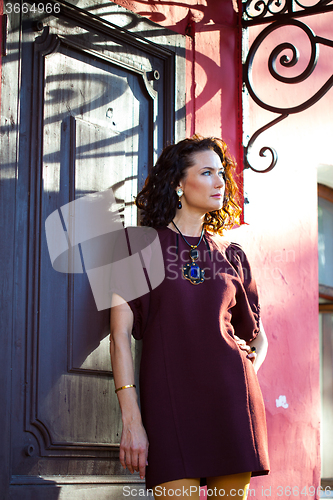 Image of beautiful middle-aged woman near the ancient door