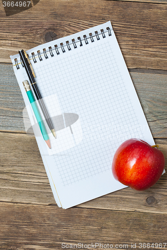 Image of still life with notebook and apple