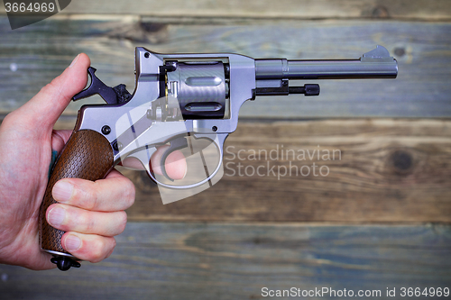 Image of revolver gun in a human hand