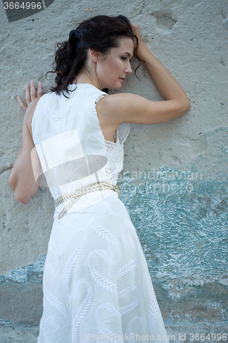 Image of beautiful middle-aged woman in a white dress