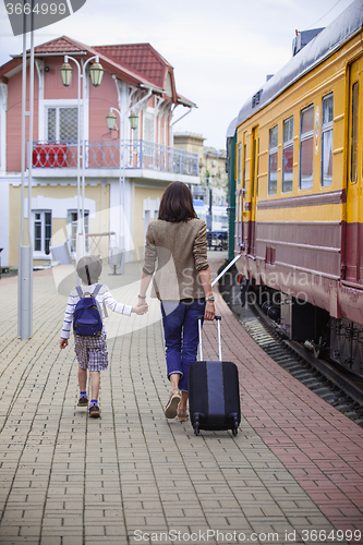 Image of Mother and son goes on the landside platform