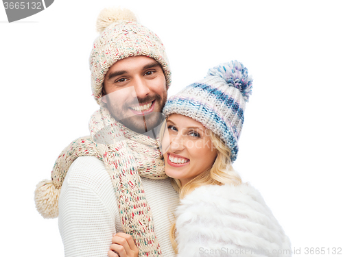 Image of smiling couple in winter clothes hugging