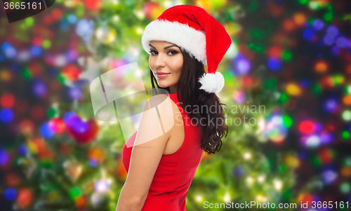 Image of beautiful sexy woman in santa hat and red dress