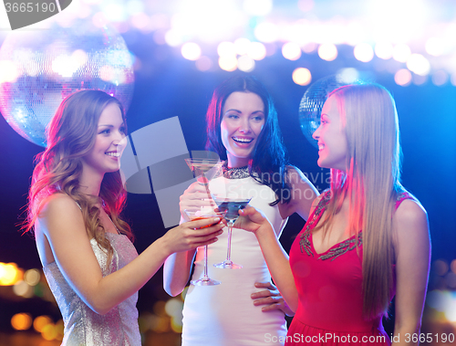 Image of smiling women with cocktails at night club