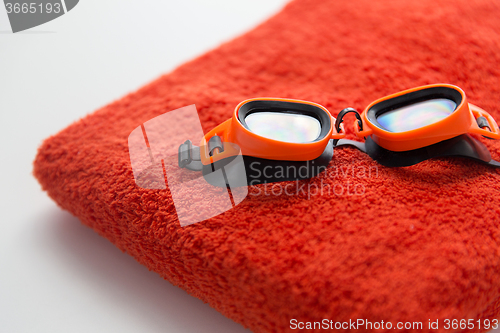 Image of close up of swimming goggles and towel
