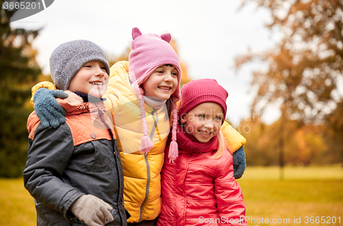 Image of group of happy children hugging in autumn park