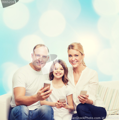 Image of happy family with smartphones