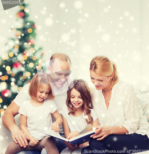 Image of happy family with book at home