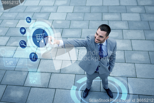 Image of young smiling businessman outdoors from top