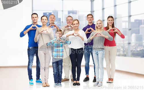 Image of group of smiling people showing heart hand sign