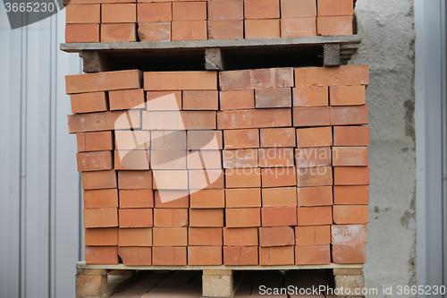 Image of brown bricks batch on wooden storage tray