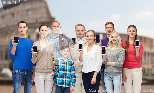 Image of group of people with smartphones over coliseum