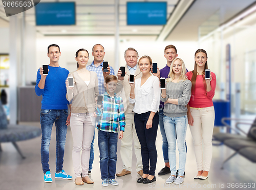 Image of group of smiling people with smartphones