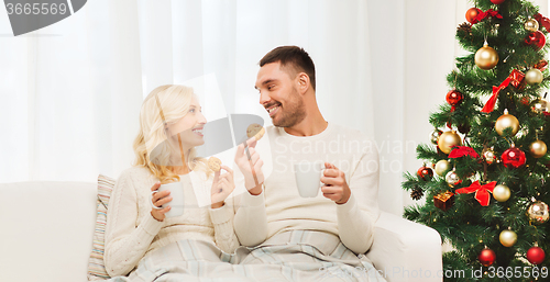 Image of happy couple at home with christmas tree