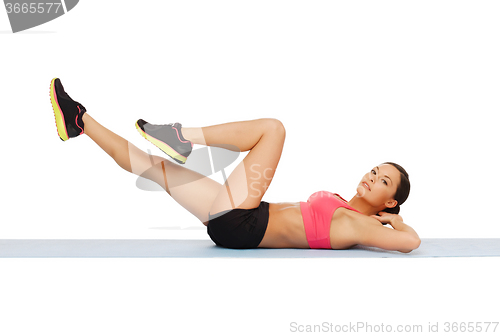 Image of sporty woman doing exercise on the floor