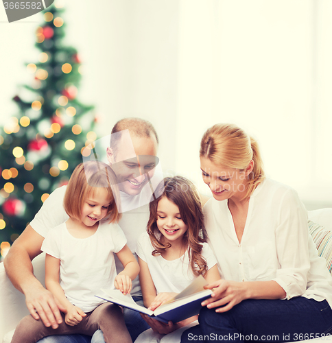 Image of happy family with book at home