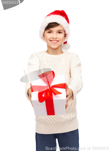 Image of smiling happy boy in santa hat with gift box