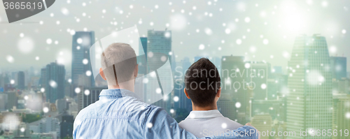 Image of close up of happy male gay couple hugging