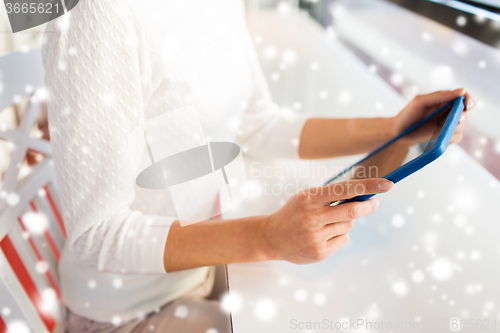 Image of close up of woman with tablet pc at cafe