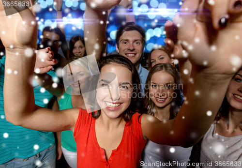 Image of smiling women dancing in club