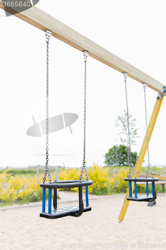 Image of baby swing on playground outdoors