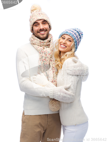 Image of smiling couple in winter clothes hugging