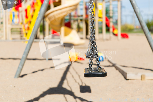 Image of close up of swing on playground outdoors