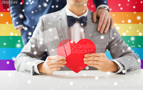 Image of close up of male gay couple with red heart