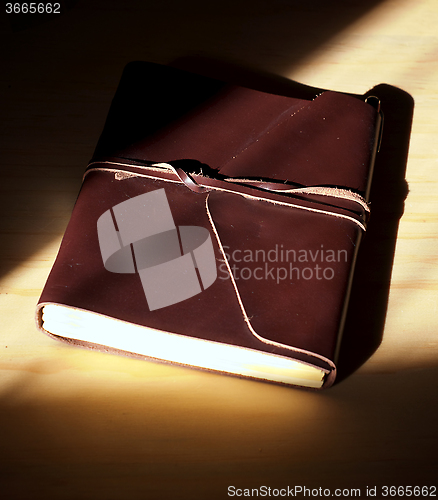 Image of glowing leather bound book