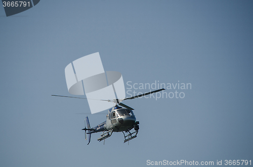 Image of one helicopter on a blue sky