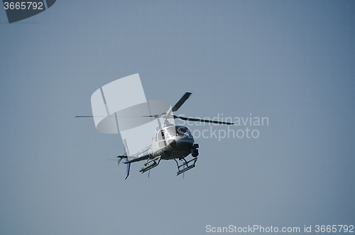 Image of one helicopter on a blue sky 