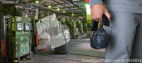 Image of Worker with protective headphone