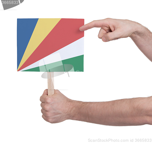 Image of Hand holding small card - Flag of Seychelles