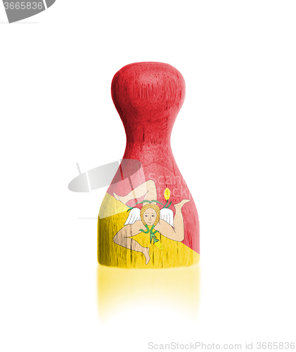 Image of Wooden pawn with a painting of a flag