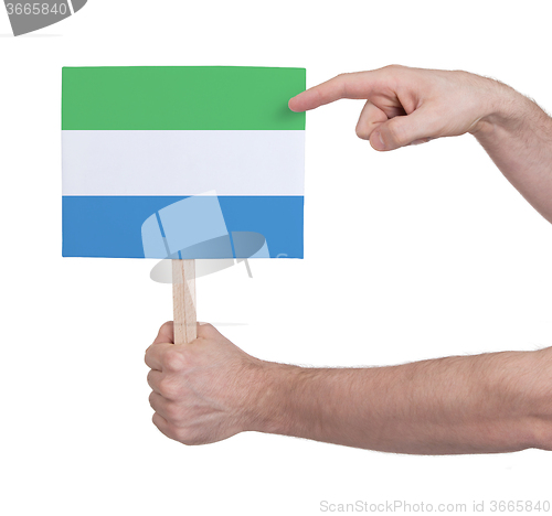 Image of Hand holding small card - Flag of Sierra Leone