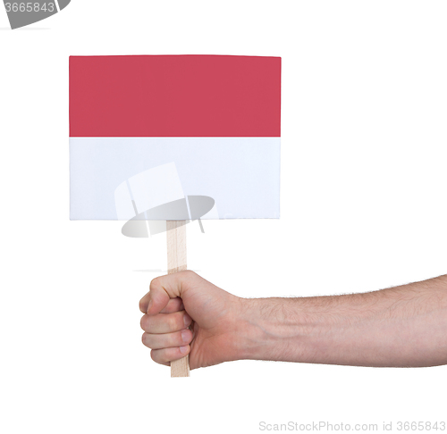 Image of Hand holding small card - Flag of Monaco