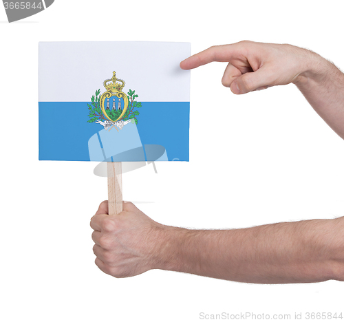 Image of Hand holding small card - Flag of San Marino