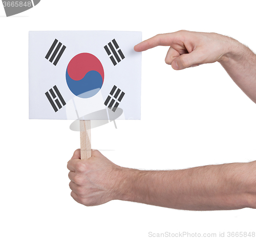 Image of Hand holding small card - Flag of South Korea